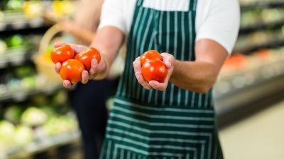 mid-section-of-worker-showing-vegetables-in-supermarket.jpg mid-section-of-worker-showing-vegetables-in-supermarket.jpg